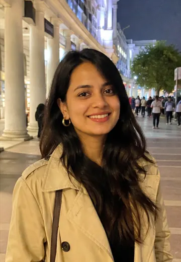 Anika smiling in a Delhi evening profile photo