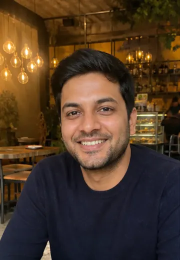 Kabir seated at a Delhi cafe in a profile photo