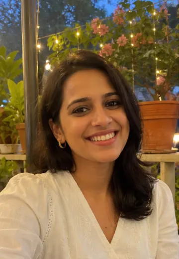 Sana smiling on a Delhi cafe terrace profile photo